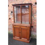A VICTORIAN GLAZED BOOKCASE OF SMALL PROPORTIONS, the upper section with two glazed doors opening to