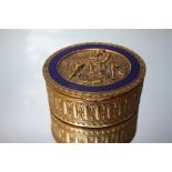 A 20TH CENTURY OVAL GILT METAL LIDDED TRINKET, with Regency style relief figural decoration with