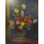 A STILL LIFE STUDY OF A VASE OF FLOWERS ON A TABLE, signed and dated 1921 lower right, oil on