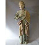 A LARGE EARLY CARVED WOOD RELIGIOUS STATUE DEPICTING A SAINT, with coloured decoration, H 85 cm