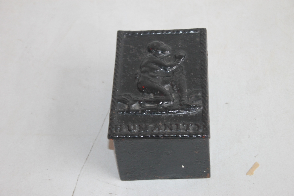 A 19TH CENTURY ANTI-SLAVERY CAST IRON TOBACCO BOX, the lift off lid depicting a chained kneeling