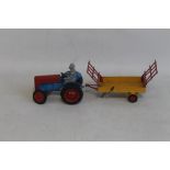 A 1950S DIECAST METTOY CASTOYS FERGUSON TE20 TRACTOR with driver figure and hay wagon A/F