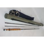 A THREE PIECE HARDY "THE FAVOURITE" GRAPHITE SALMON ROD, with cork handle in a canvas bag and hard