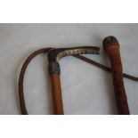 SWAINE & CO. WHITE METAL MOUNTED RIDING CROP, along with an Oriental carved walking stick (2)