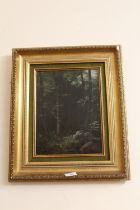 A GILT FRAMED OIL ON CANVAS OF A WOODED LANDSCAPE