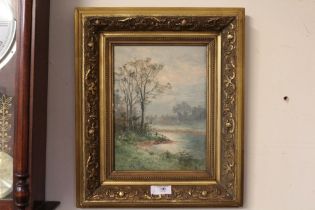 A GILT FRAMED WATERCOLOUR OF AN EARLY MISTY RIVER LANDSCAPE A/F