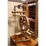 A WOODEN SPINNING WHEEL