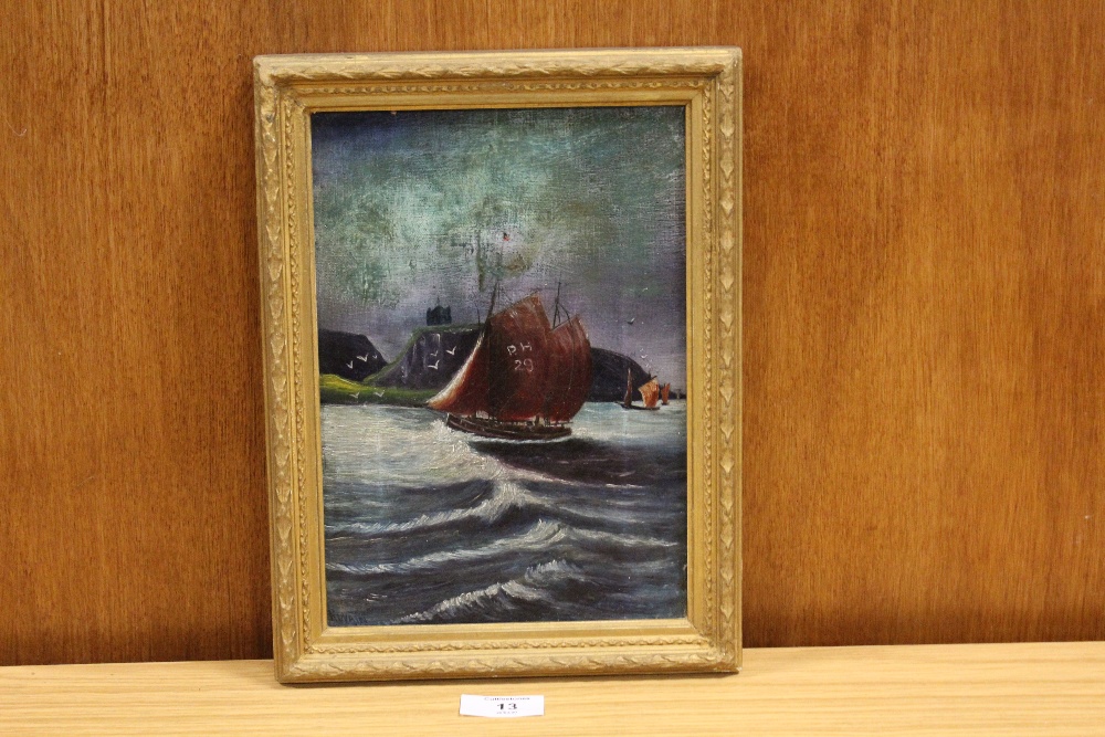 A GILT FRAMED OIL ON PANEL OF A FISHING BOAT AT SEA,