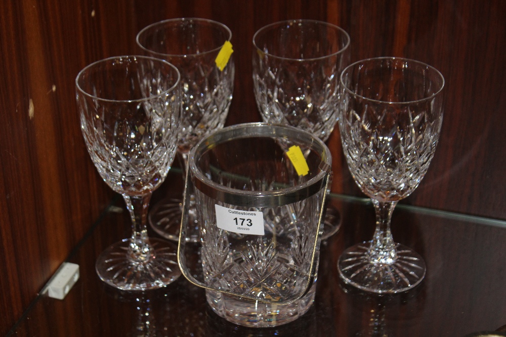 A SET OF FOUR CUT GLASS WINE GLASSES TOGETHER WITH A CUT GLASS ICE BUCKET