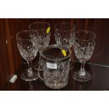 A SET OF FOUR CUT GLASS WINE GLASSES TOGETHER WITH A CUT GLASS ICE BUCKET