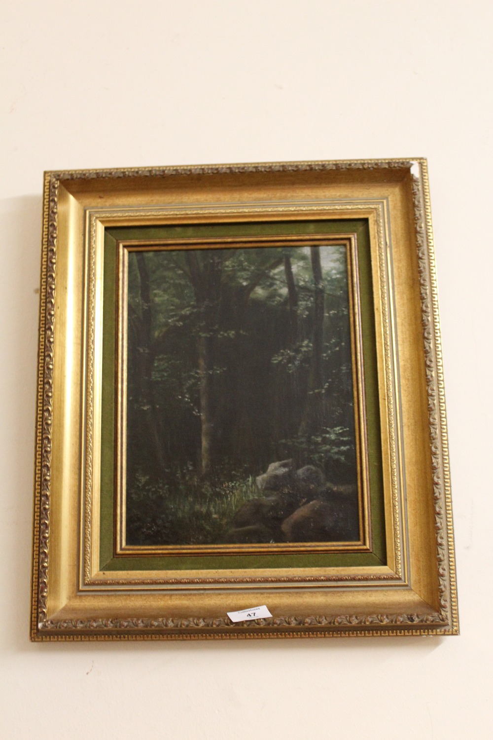 A GILT FRAMED OIL ON CANVAS OF A WOODED LANDSCAPE