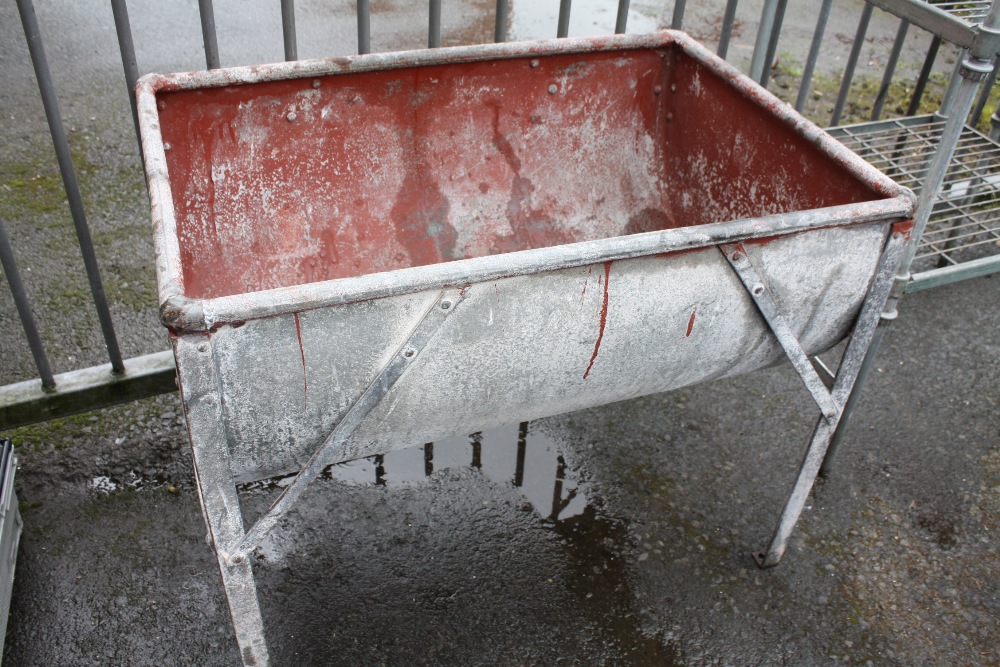 A GALVANIZED TROUGH ON STAND