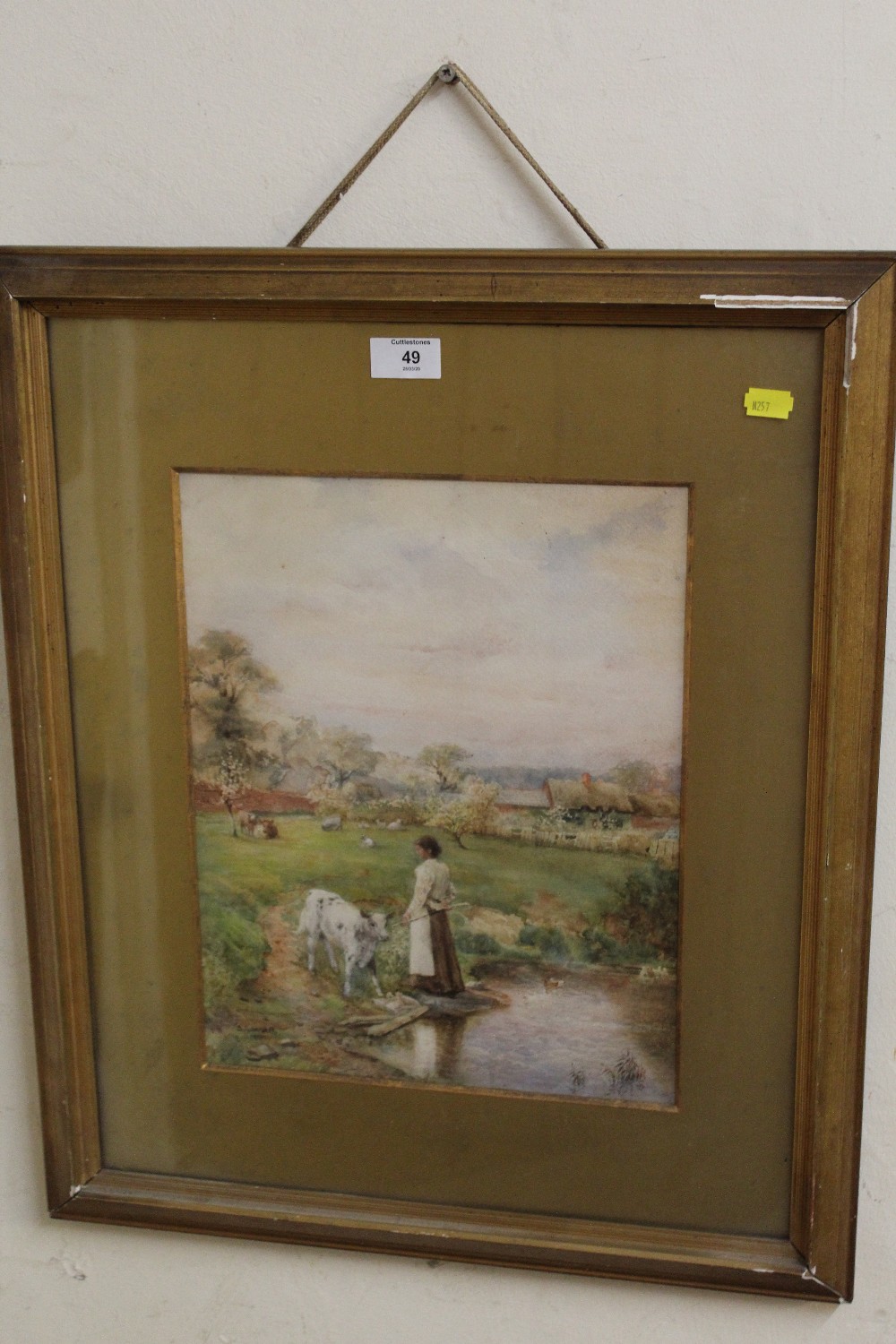 A FRAMED AND GLAZED WATERCOLOUR OF A GIRL WATERING CALFS SIGNED LOWER RIGHT S GARRETT