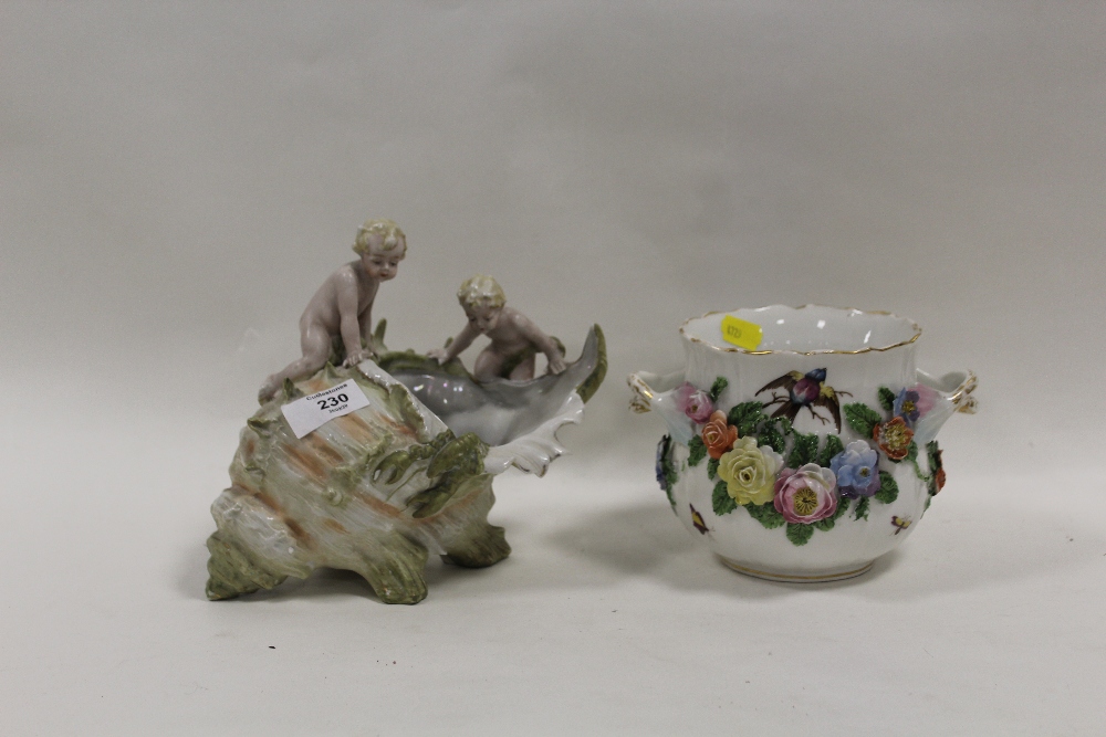 A CONTINENTAL DECORATIVE CONCH SHELL WITH TWO CHERUBIC FIGURES TOGETHER WITH A TWIN HANDED VASE WITH