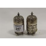 A PAIR OF HALLMARKED SILVER ORNATE PEPPERETTES