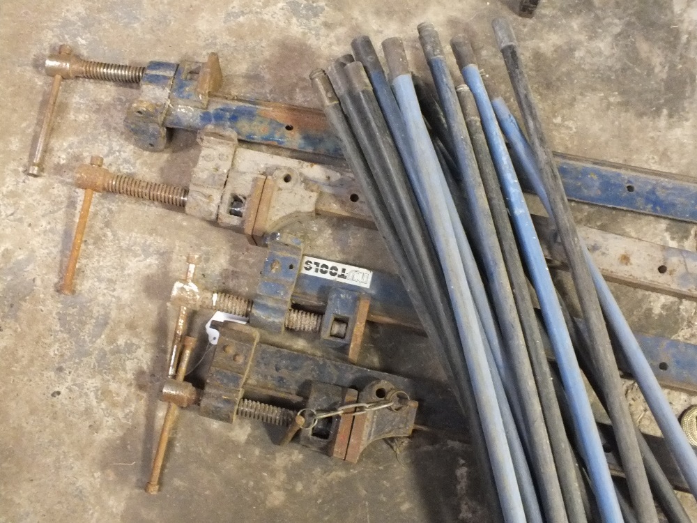 FOUR LARGE CAST METAL CLAMPS TOGETHER WITH DRAIN RODS