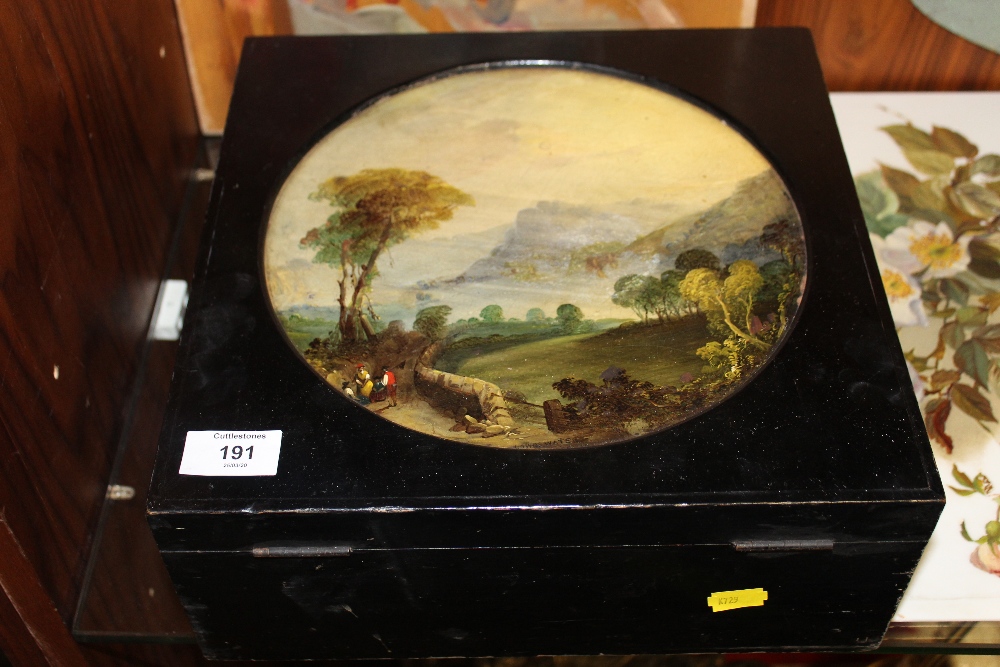 A VINTAGE STORAGE BOX WITH CIRCULAR PAINTED LANDSCAPE DECORATION TO LID