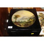 A VINTAGE STORAGE BOX WITH CIRCULAR PAINTED LANDSCAPE DECORATION TO LID