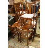 AN OAK DRAWLEAF DINING TABLE AND SIX OAK CHAIRS