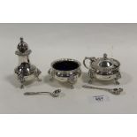 A HEAVY GAUGE HALLMARKED SILVER THREE PIECE CRUET SET WITH LION MASK DETAIL TOGETHER WITH SILVER