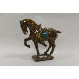 A BESWICK TANG HORSE MODEL 2137Condition Report:Pinhole flaw just above front right leg, light