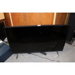 A SAMSUNG FLATSCREEN TV WITH REMOTE