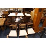 A LARGE CONTEMPORARY MAHOGANY TWIN PEDESTAL DINING TABLE - WITH TWO EXTRA LEAVES AND TEN CHAIRS -