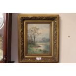 A GILT FRAMED WATERCOLOUR OF AN EARLY MISTY RIVER LANDSCAPE A/F