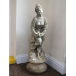 A FIGURATIVE GARDEN ORNAMENT OF A LADY WITH A BIRD