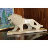 AN ONYX MODEL OF A LION ON BASE