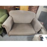 AN ANTIQUE DROP ARM UPHOLSTERED SOFA
