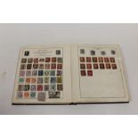 A 'THE STRAND' STAMP ALBUM CONTAINING BRITISH AND WORLD STAMPS TO INCLUDE PENNY REDS, TWO PENNY BLUE