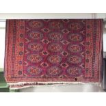 AN OLD HAND KNOTTED PERSIAN TYPE RUG - 244 X 178 CM CONDITION - TWO RECTANGULAR HOLES TOWARDS THE