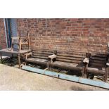 A WOODEN GARDEN TABLE TOGETHER WITH TWO BENCHES AND TWO CHAIRS