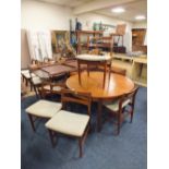 A RETRO TEAK EXTENDING DINING TABLE AND 6 CHAIRS