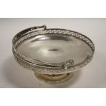 A HALLMARKED SILVER SWING HANDLED TAZZA - BIRMINGHAM 1923, reticulated band to edge of bowl, similar