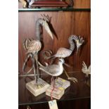 TWO UNUSUAL SPRING NECKED BIRD FIGURES ON WOODEN PLINTHS together with a smaller wooden bird