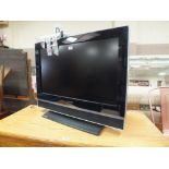 A HUMIX LCD 31" FLATSCREEN TV - REMOTE / INSTRUCTIONS