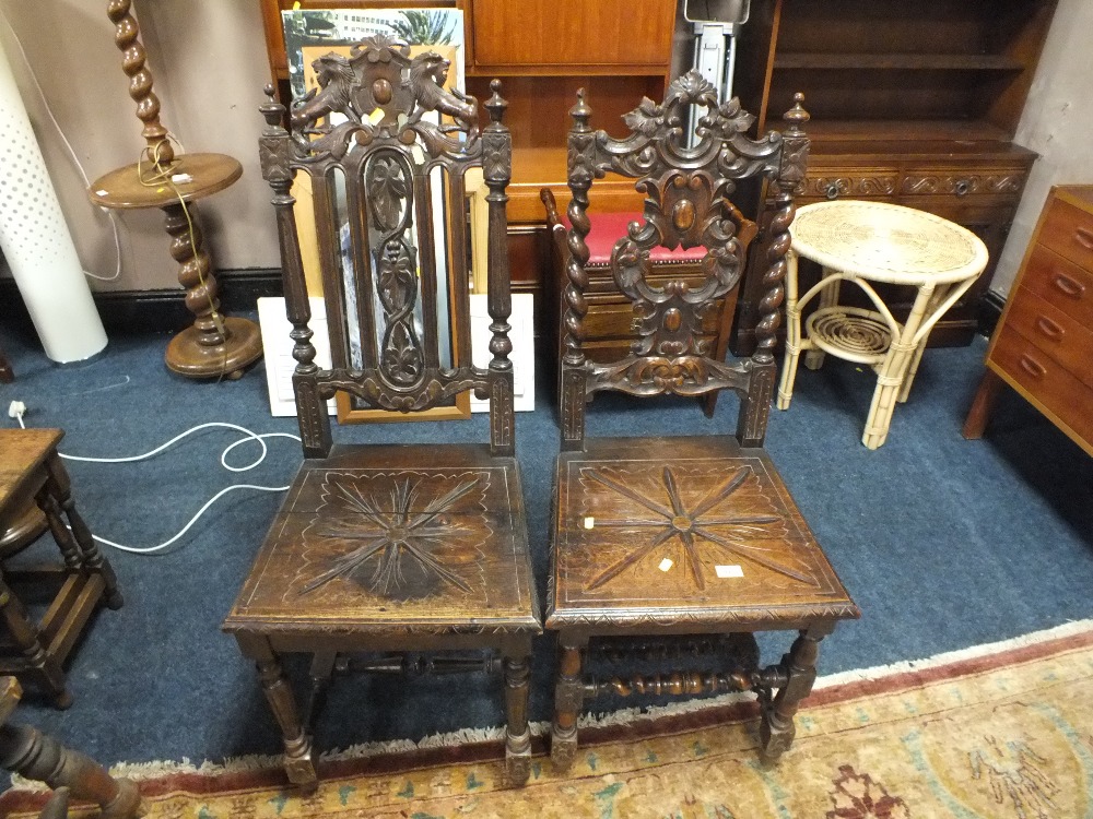 A NEAR PAIR OF ANTIQUE OAK CARVED JACOBEAN TYPE CHAIRS