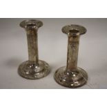 A PAIR OF HALLMARKED SILVER CANDLESTICKS - BIRMINGHAM 1905, with swags and tail decoration, engraved