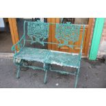 A PAINTED GREEN METAL BENCH