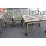 A WOODEN GARDEN TABLE AND 4 MATCHING CHAIRS ON CASTORS