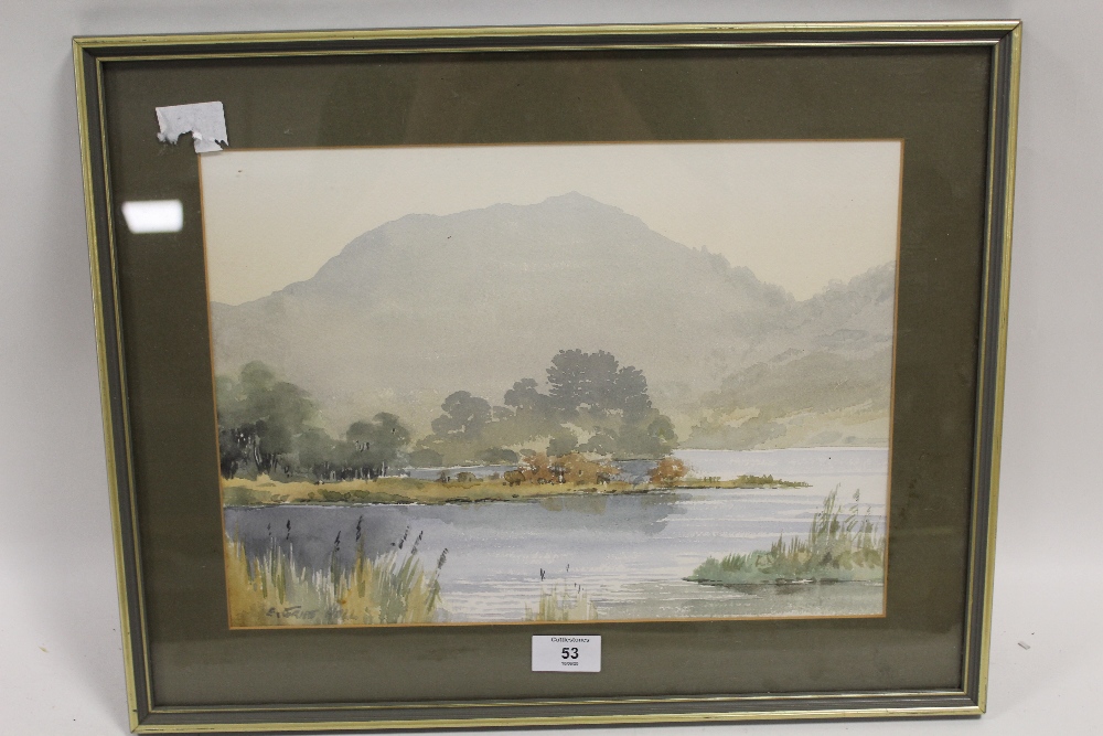 E. GREIG HALL - A FRAMED AND GLAZED WATERCOLOUR OF A LAKE LAND SCENE signed lower left 38cm x 48cm