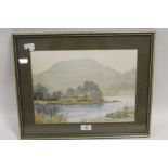 E. GREIG HALL - A FRAMED AND GLAZED WATERCOLOUR OF A LAKE LAND SCENE signed lower left 38cm x 48cm