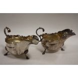 A PAIR OF SILVER PLATED SAUCE BOATS, makers marks for H & H, each raised on three outswept feet, W