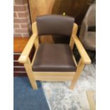 A MODERN UPHOLSTERED MOBILITY COMMODE ARM CHAIR