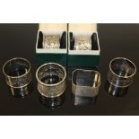 FOUR ASSORTED HALLMARKED SILVER NAPKIN RINGS, together with two 90% silver examples (6)