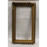 A 19TH CENTURY DECORATIVE GILT FRAME, frame W 9 cm, rebate size 84 x 41 cm