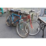 A BLUE RALEIGH ALASKA ROAD BIKE TOGETHER WITH A RED INTEGRA PHANTOM BICYCLE