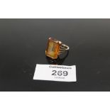 A GOLD LADIES DRESS RING SET WITH LARGE CITRINE STONE - HALLMARKS RUBBED